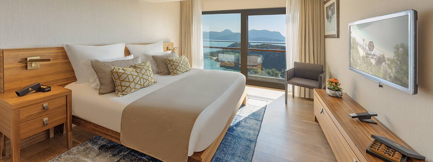 A classic room at the D Maris Bay resort. A contemporary bedroom with modern decor, looks out to a spectacular sea view. 