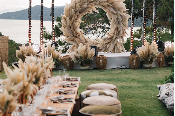  A wedding set up at D Maris Bay, with a large decorative dried wreath, overlooking the sea,
