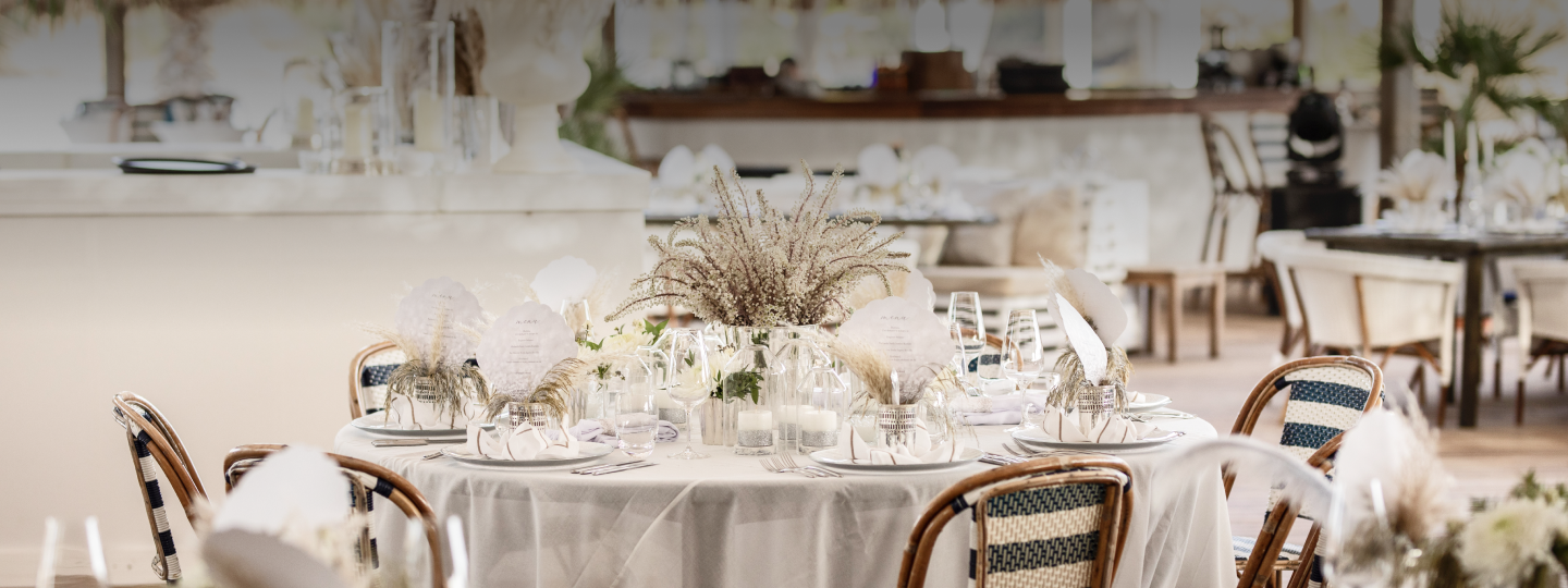 A beige and cream wedding table decoration with a dried flower centrepiece at D Maris Bay.