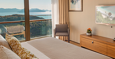A view from one of the deluxe rooms of the D Maris Bay resort. The luxurious bedroom looks out on a sea view. 