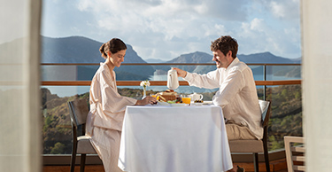  A couple enjoy an al fresco breakfast on the balcony of their room at the D Maris Bay resort