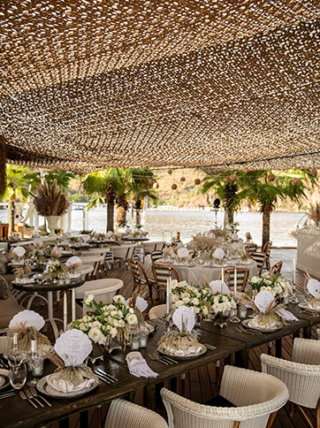  The brown and beige wedding tables adorned with fresh bouquets of flowers at La Guerite bar in D Maris Bay.